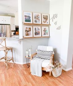 a living room filled with furniture and pictures on the wall above it's counter