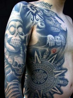 a man with tattoos on his chest and arm