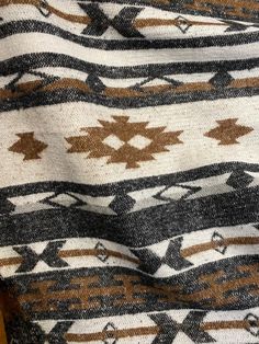 a brown and white blanket sitting on top of a wooden table