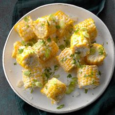 a white plate topped with corn and cheese