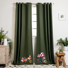 the curtains are green and decorated with flowers