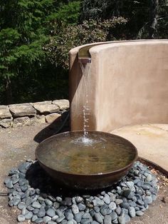 an outdoor fountain with rocks and water coming out of it