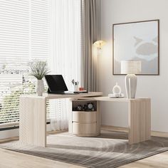 a laptop computer sitting on top of a wooden desk next to a white vase and lamp