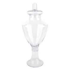 a clear glass vase with a lid on the top and bottom, sitting in front of a white background