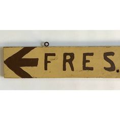 a wooden sign that says free with an arrow pointing to the right