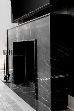 a large black marble fireplace in a living room