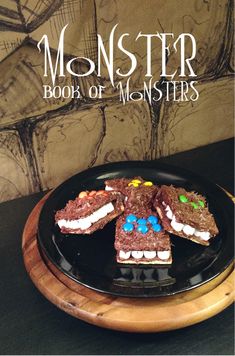 a black plate topped with brownies covered in marshmallows and monster eyes