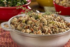 a bowl filled with rice and vegetables on top of a table