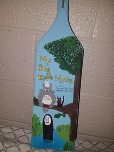 a bottle shaped like a tree with an image of a cat and a bear on it