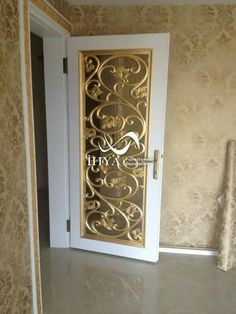 an open door in the corner of a room with gold wallpaper and ornate designs