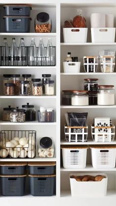 an organized pantry with white shelves and baskets