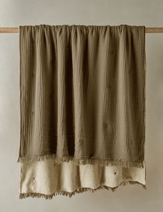 a tan curtain hanging on a clothes line