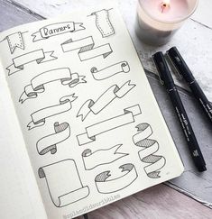 an open notebook with hand drawn banners and candles