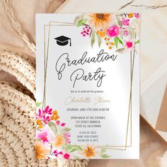 a graduation party card with flowers and a mortar cap on it next to a wicker basket