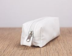 "The rectangular pencil case in white soft sheep leather. This pencils case was made to carry around your purse. Customize it in fabric or leather in your favorite color combination and why not mix and match it with one of the other bags in my shop http://etsy.me/1haNFVO Inside the bag, the lining is made using a cotton floral fabric. The top closes using a nylon zipper with silver colored hardware. Aprox. dimensions: The bottom is measuring 7\" x 5\" (18cm x 5cm) and the height of this pouch is White Pencil Case, Pencils Case, School Wishlist, Pencil Cases For Girls, Cotton Purse, School Pencil Case, Leather Pencil Case, Job Ideas, Glass Repair