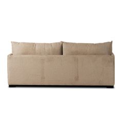 a beige couch with two pillows on it