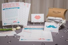 an assortment of wedding stationery items displayed on a table with tulips and paper