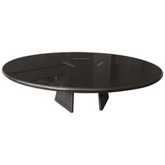 an oval glass table with black legs and a metal base, on a white background