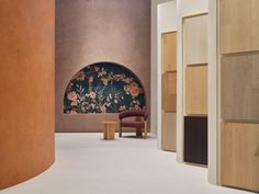 the interior of a room with wooden walls and floral wallpaper on the back wall