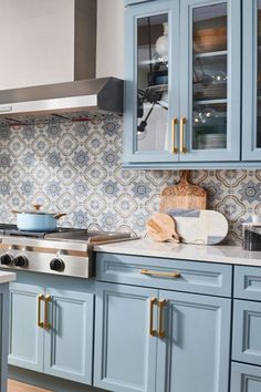 a kitchen with blue cabinets and white counter tops