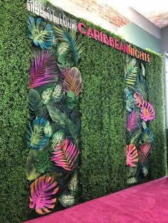 the carpet is pink and green in front of a wall with tropical leaves on it