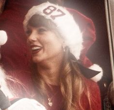 a woman wearing a santa hat and holding a baby