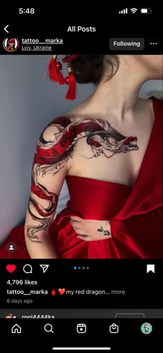 a woman in a red dress with tattoos on her arm