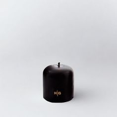 an apple sitting on top of a white table next to a black object with the word hig written on it