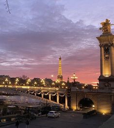 the eiffel tower is lit up at night