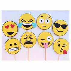 a group of yellow smiley face cupcake toppers with sunglasses and hearts on them