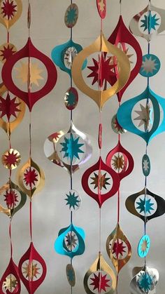 a group of ornaments hanging from a ceiling in the shape of stars and circles,