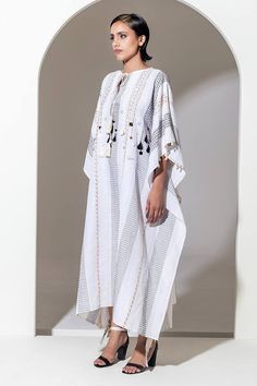 White bead, sequin and embroidered kaftan lined with cowire shells. Comes with a slip. - Aza Fashions Festive Resham Embroidery Kaftan For Beach, Spring Embellished Tunic Kaftan, Elegant White Kaftan For Festival, Festive Embellished White Thobe, Festive White Embellished Thobe, Bohemian Sequin Kaftan For Festivals, Bohemian Festival Kaftan With Sequins, Elegant Embroidered Kaftan For Vacation, Traditional Embellished Dresses For Vacation