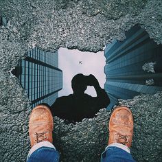 a person standing in the middle of a street with their feet up on the ground