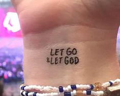 a person with a tattoo that says let go and let god