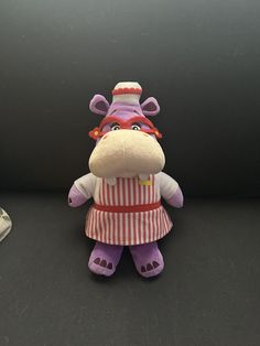 This 8-inch plush toy is a must-have for any Doc McStuffins fan! The character, Nurse Hallie Hippo, is a beloved member of the Doc McStuffins family. The toy is made of high-quality plush material and features a purple color scheme. It is perfect for collectors or as a gift for children who love the Doc McStuffins franchise. The toy is manufactured in Vietnam and is an officially licensed Disney product. This stuffed toy is a great addition to any collection and is sure to bring joy to anyone who loves Doc McStuffins. Purple Color Schemes, Doc Mcstuffins, Action Figure Accessories, Stuffed Toy, Disney Store, Purple Color, Plush Toy, Color Scheme, Gifts For Kids