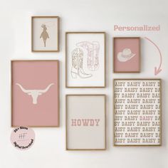 a white wall with pink and brown framed art on it's sides, along with personalized baby items