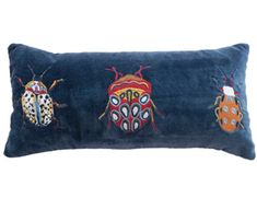 three bugs on a blue velvet pillow