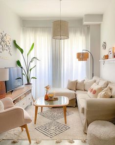 a living room filled with furniture and a flat screen tv on top of a wooden stand