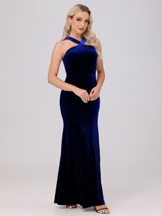 a woman wearing a blue velvet gown with one shoulder cut out and an open back