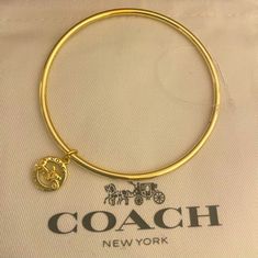 Nwot New Never Used. Coach Horse And Carriage Bangle Bracelet W Charm Coach Bangle Bracelet With Charm. Charm In Gold Over Brass! Comes In Black Unbranded Box. Perfect For The Coach Collector! Card And Dust Bag Is For Pic Purposes Only. Coach Metal Bracelet Jewelry, Coach Bracelets As Gift, Coach Adjustable Bangle, Adjustable Coach Bangle, Adjustable Logo Charm Bracelet, Coach Metal Bangle Jewelry, Coach Gold Bangle Bracelet, Coach Bangle Bracelets Gift, Coach Adjustable Bracelet As Gift