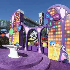 the inside out entrance to an amusement park with lights and decorations on it's sides