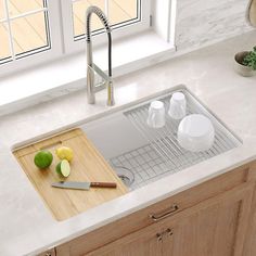 a kitchen sink with a cutting board on the counter