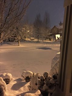 the snow is piled up on the outside of the house in front of the door