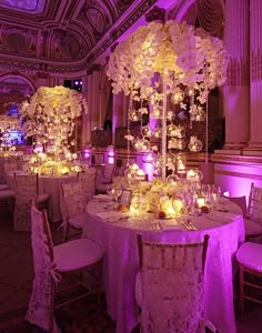 the tables are set up with candles and centerpieces for an elegant wedding reception