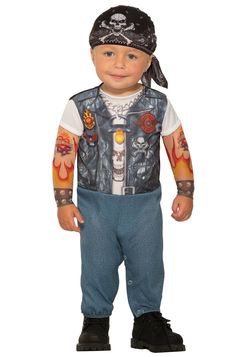 a little boy wearing a costume with tattoos on his arm and chest, standing in front of a white background