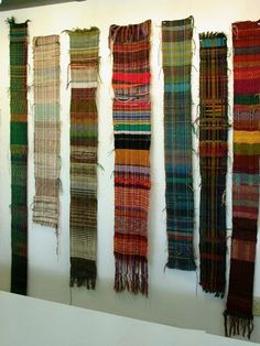 the wall is lined with different types of weavings