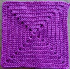 a crocheted square with holes in the middle