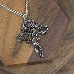 Antiqued Pewter pendant Red enameled rose petals Made in the UK 17″ stainless-steel chain included Measures 1 1/4″ x 1 3/4″ Really nice Rosycroix Rose Cross Necklace! Antiqued pewter rose pendant, with red enameled petals. 17″ stainless-steel chain included. Measures 1 1/4″ x 1 3/4″. Antiqued Pewter. Made in the UK. Rose Mary Necklace, Rose-colored Gothic Jewelry For Gift, Regal Rose Necklace, Gothic Red Nickel-free Necklace, Rose Red Flower Necklaces With Rose Design, Great Kilt, Pewter Pendant, Rose Pendant, Antique Pewter