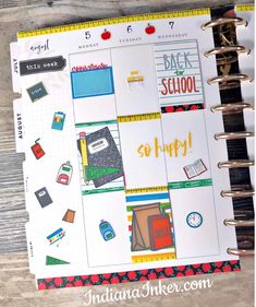 the back to school planner book is open and has stickers on it, along with other items