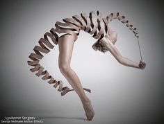 a woman in black and white poses with her legs spread out as she holds a string